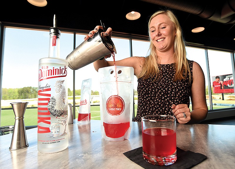 Staff Photo by Matt Hamilton / Sydney Flerl makes the Cardiac Punch drink at CHI Memorial Stadium on Thursday, April 14, 2022.