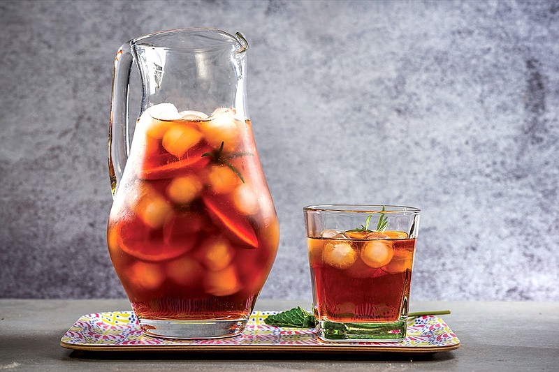 Iced peach tea in jug, summer refreshing drink.