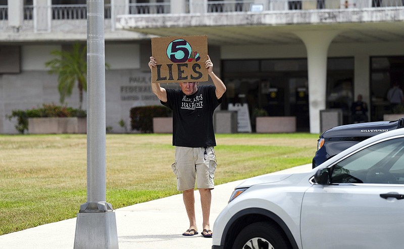 A Trump supporter wearing a Trump mask walks outside the Paul S. Rogers Federal Building and U.S. Courthouse in downtown West Palm Beach, Fla., before documents were released by The Justice Department explaining the justification for an FBI search of former President Donald Trump's Florida estate earlier this month, when agents removed top secret government records and other classified documents.  The 32-page affidavit, even in its heavily redacted form, offers the most detailed description to date of the government records being stored at Trump's Mar-a-Lago property long after he left the White House and reveals the gravity of the government's concerns that the documents were there illegally. (AP Photo/Jim Rassol) (AP Photo/Jim Rassol)
