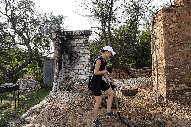 Ukrainian volunteers rebuild a destroyed home in the village of Krasne, outside of Chernihiv, Ukraine on Aug. 27, 2022. Millions of Ukrainians have been displaced from their homes because of the war over the last six months, and many homes were destroyed. Groups of volunteers are working around the country to clean up debris and repair homes. (Lynsey Addario/The New York Times) — NO SALES —