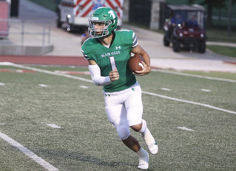 Blair Oaks quarterback Dylan Hair looks for an opening on a carry during the first half of Friday night’s game against Maryville in the Kickoff Classic at UCM’s Walton Stadium in Warrensburg. (Greg Jackson/News Tribune)