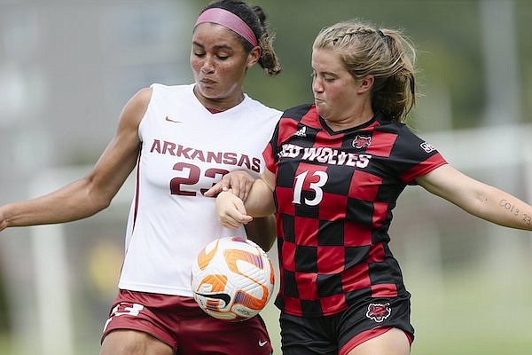 Arkansas defender Ella Riley (23) and Arkansas State midfielder/forward Phoebe Harpole (13) battle for possession during a game Sunday, Aug. 28, 2022, in Fayetteville.
