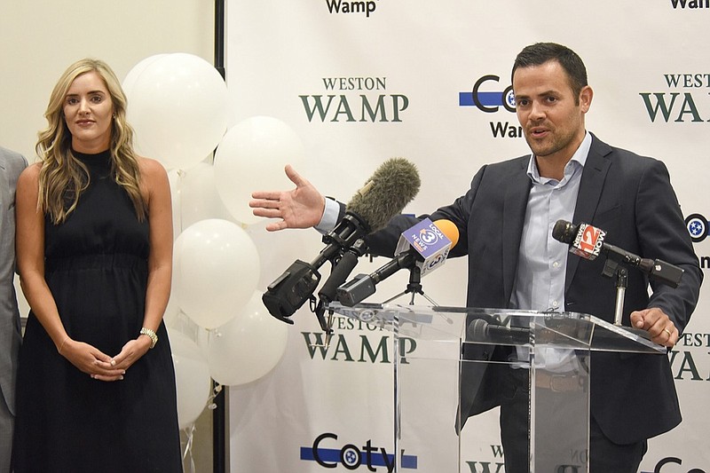 Staff photo by Matt Hamilton / Coty Wamp looks on as Weston Wamp talks to his supporters and members of the media at the Edwin Hotel in Chattanooga on Thursday, August 4, 2022.