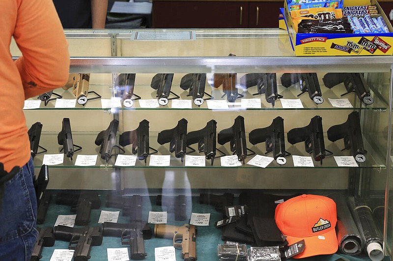 FILE - Handguns are on displayed at a gun shop, Thursday, June, 23, 2022 in Honolulu. In Hawaii it's traditionally been practically impossible to obtain police permission to carry a loaded gun in public and so far that hasn't changed even after a U.S. Supreme Court ruling making it easier to get such permits. Since the decision in June, only one permit has been granted. (AP Photo/Marco Garcia, File)