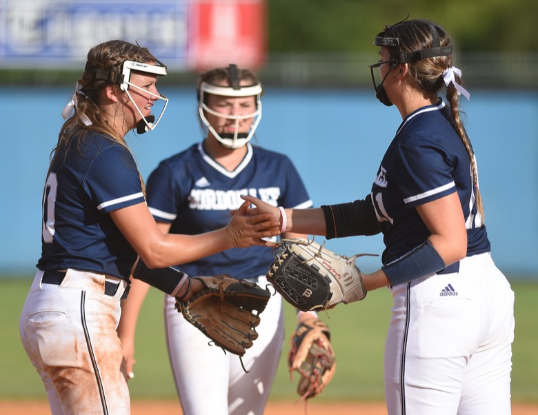 Staff photo by Matt Hamilton / Gordon Lee (10) Tenslee Wilson, (11) Sydney Garrett and (12) Gracie Helton talk at the start of an inning on Tuesday, August 30, 2022 at Ringgold High School.