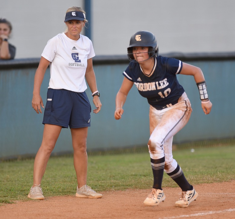 Staff photo by Matt Hamilton / Gordon Lee (10) Tenslee Wilson prepares to run home as head coach Dana Mull looks on on Tuesday, August 30, 2022 at Ringgold High School.
