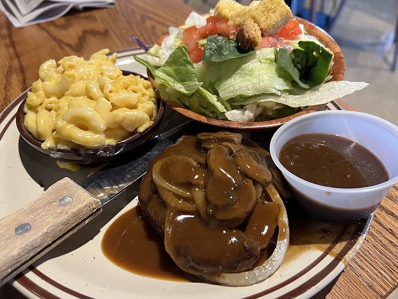 Sauteed mushrooms and onions and brown gravy top the Smothered Hamburger Steak (clockwise from down center), with side mac & cheese, a tossed side salad and a cup of balsamic vinaigrette. (Arkansas Democrat-Gazette/Eric E. Harrison)