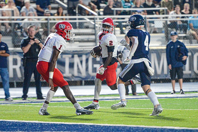 Fort Smith Northside T’Kavion King (middle) runs for a touchdown in front of a teammate and a Greenwood defender Friday during the Grizzlies’ 56-53 loss to the Bulldogs at Smith-Robinson Stadium in Greenwood. More photos at arkansasonline.com/93fsnghs/.
(NWA Democrat-Gazette/Hank Layton)