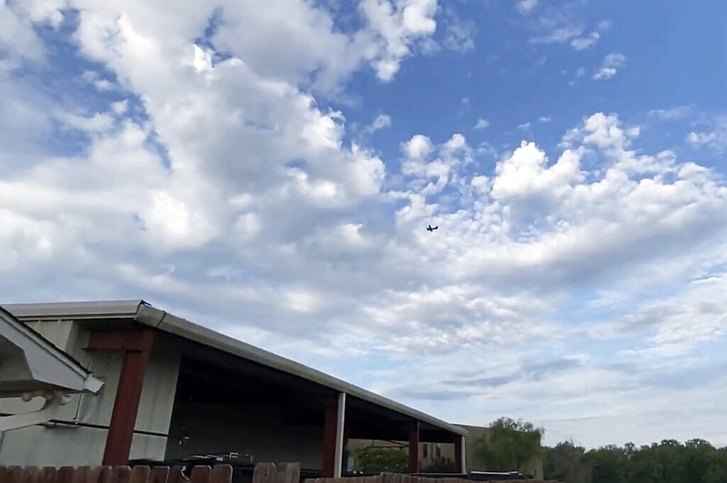 A small airplane circles over Tupelo, Miss., on Saturday, Sept. 3, 2022. Police say the pilot of the small airplane is threatening to crash the aircraft into a Walmart store. (Rachel McWilliams via AP)