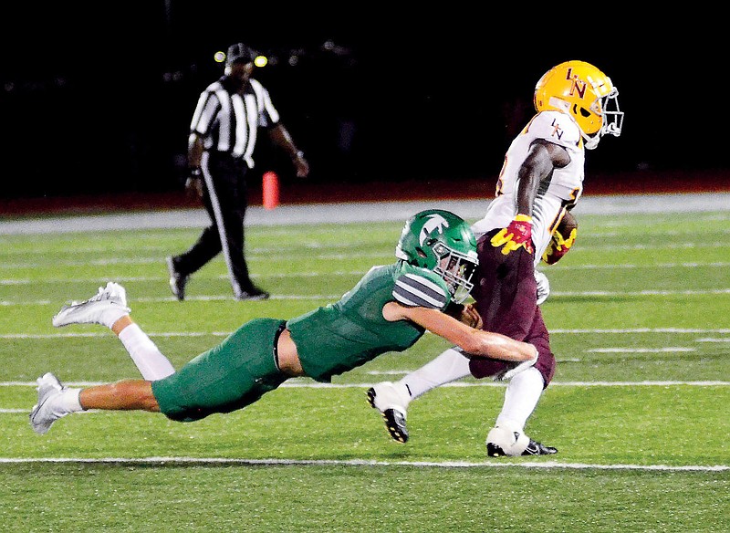 Alec Wieberg of Blair Oaks tackles Lutheran North’s Vance Gross during Friday night’s game at the Falcon Athletic Complex in Wardsville. (Eileen Wisniowicz/News Tribune)