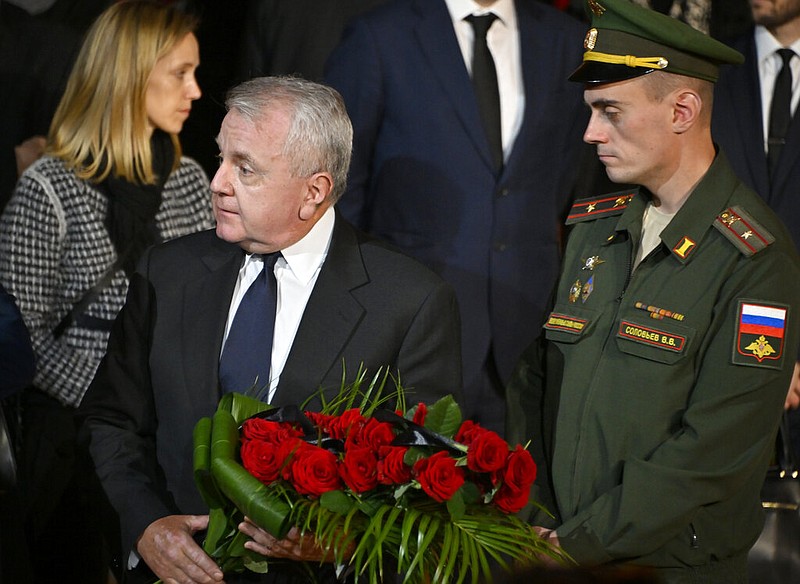 U.S. ambassador to Russia John Joseph Sullivan, centre, walks to the coffin of former Soviet President Mikhail Gorbachev inside the Pillar Hall of the House of the Unions during a farewell ceremony in Moscow, Russia, Saturday, Sept. 3, 2022. (Alexander Nemenov/Pool Photo via AP)