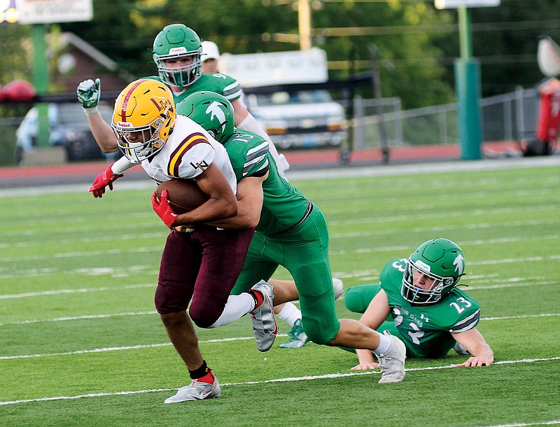 Brady Kerperin of Blair Oaks tackles Lutheran North’s Mikel Harris during Friday night’s game at the Falcon Athletic Complex in Wardsville. (Eileen Wisniowicz/News Tribune)