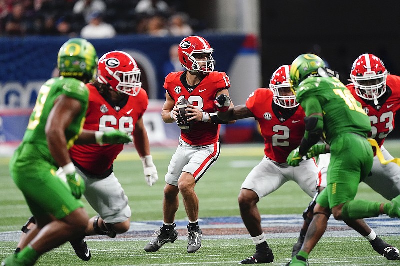 Georgia quarterback Stetson Bennett (13) throws from the pocket in the first half of an NCAA college football game against the Oregon Saturday, Sept. 3, 2022, in Atlanta. (AP Photo/John Bazemore)