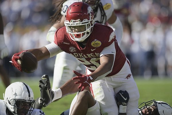 Arkansas running back Dominique Johnson carries the ball during the Outback Bowl against Penn State on Saturday, Jan. 1, 2022, in Tampa, Fla.