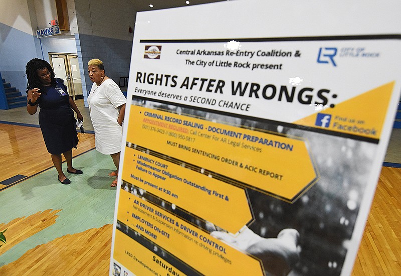 Chandra Martin (left) of the Little Rock School District and Leta Anthony of the Central Arkansas Re-Entry Coalition converse Wednesday following a news conference about the upcoming Rights After Wrongs event at the Little Rock School District Developmental Training Center.
(Arkansas Democrat-Gazette/Staci Vandagriff)