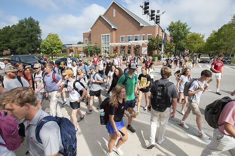 Students bustle across the University of Arkansas campus on Wednesday in Fayetteville. “We’re growing and thriving,” said Mark Rushing, associate vice chancellor for university relations. UA has achieved record enrollment this fall with 30,936 students, including 7,099 freshmen, also a record.
(NWA Democrat-Gazette/J.T. Wampler)