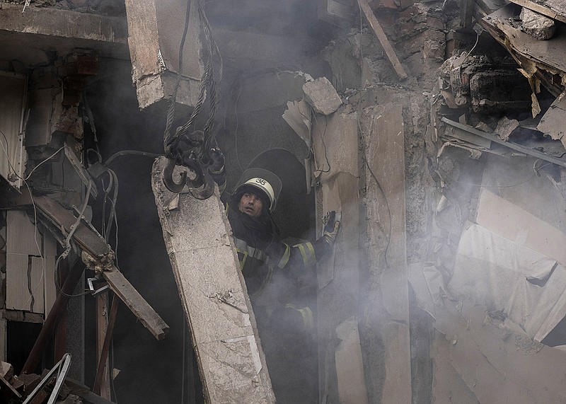 A firefighter looks for victims Wednesday in Sloviansk, Ukraine, after a Russian attack heavily damaged a residential building.
(AP/Leo Correa)