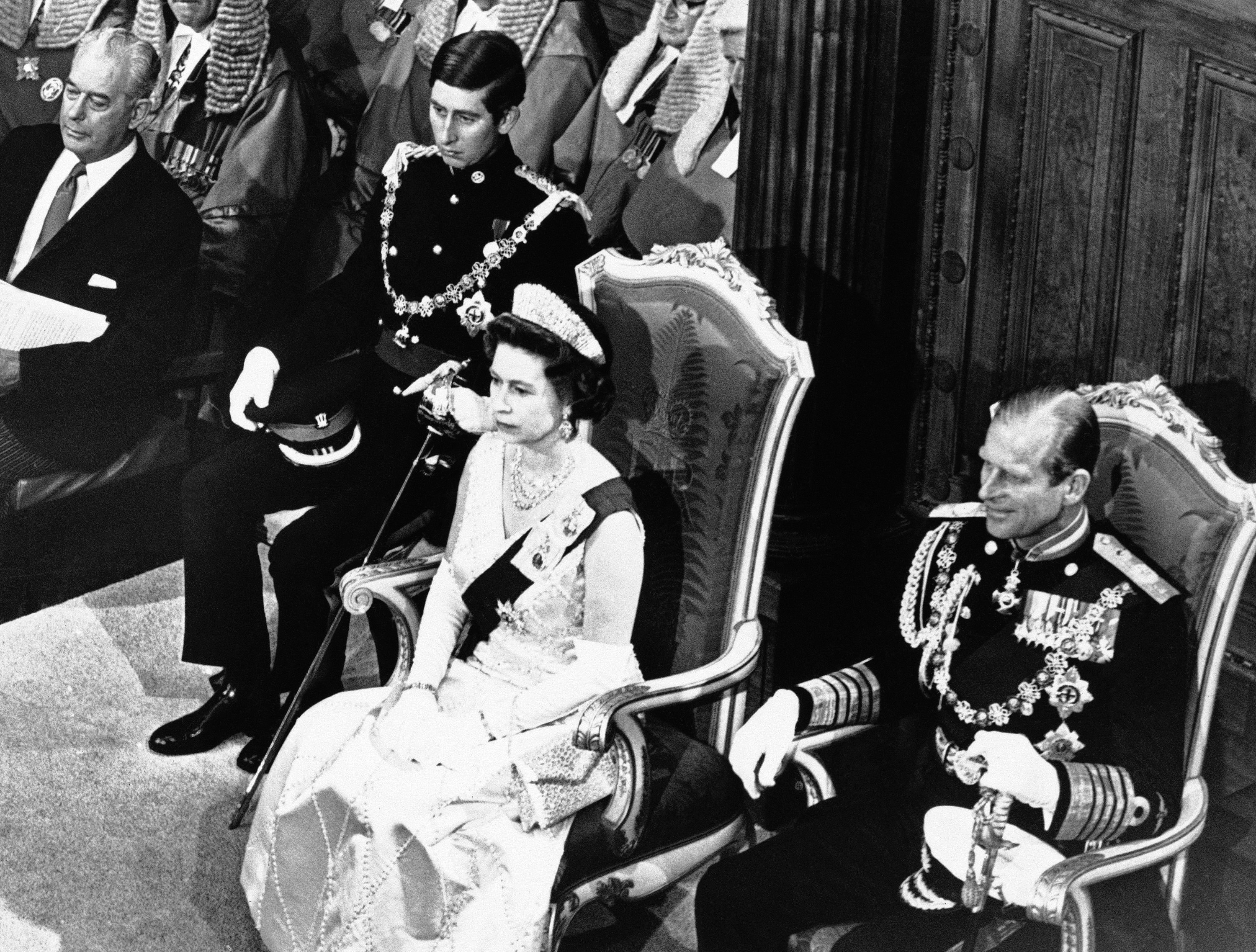 FILE - In this March 13, 1970 file photo, Britain's Queen Elizabeth II, centre, sits in the Chamber in Wellington, where she formally opened the Parliament with Prince Charles at left and Prince Philip on the right, in London. Prince Charles has been preparing for the crown his entire life. Now, that moment has finally arrived. Charles, the oldest person to ever assume the British throne, became king on Thursday Sept. 8, 2022, following the death of his mother, Queen Elizabeth II. (AP Photo, File)