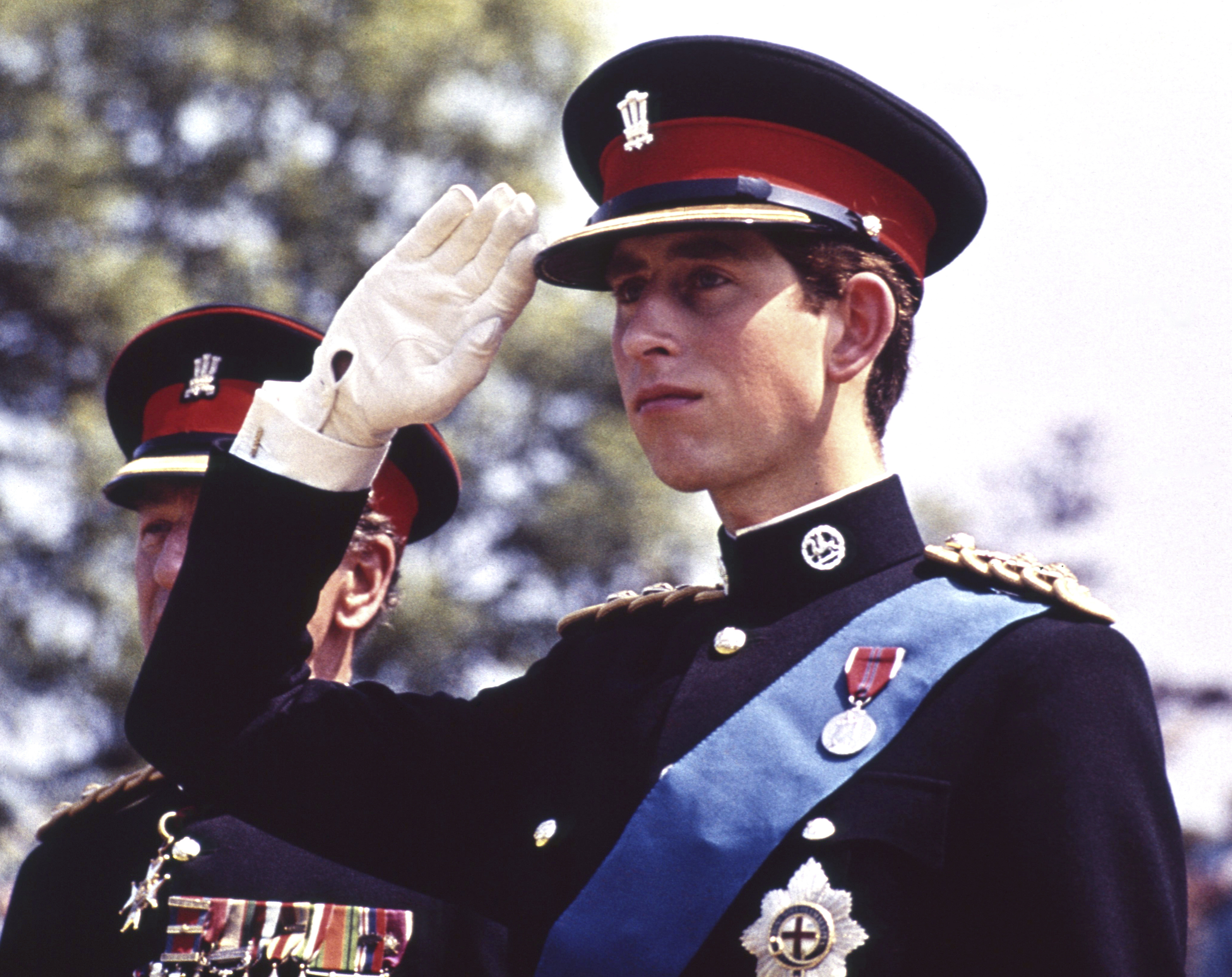 FILE  - In this June 11, 1969 file photo, Britain's Prince Charles, dressed in the uniform of the Colonel in Chief of the Royal Regiment of Wales, salutes at the Regiment's Colour presentation, at Cardiff Castle in Wales. It was the first occasion for the Prince to wear uniform. Prince Charles has been preparing for the crown his entire life. Now, that moment has finally arrived. Charles, the oldest person to ever assume the British throne, became king on Thursday Sept. 8, 2022, following the death of his mother, Queen Elizabeth II. (AP Photo, File)