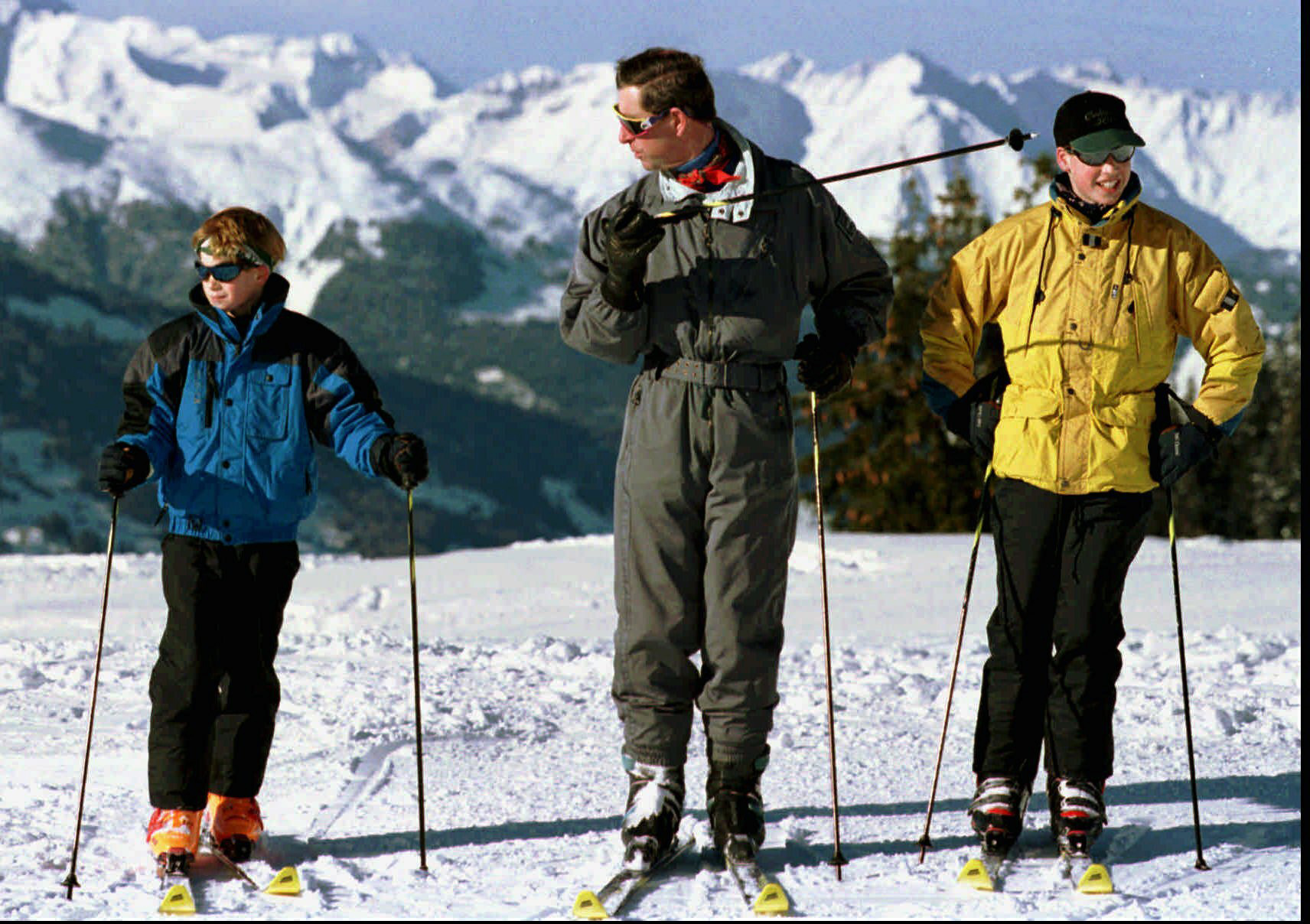 FILE - In this Tuesday, Jan. 2, 1996 file photo, Britain's Prince Charles leads his sons Harry, left, and William onto the slopes above the alpine skiing resort of Klosters in Switzerland on the first full day of their skiing holiday. Prince Charles has been preparing for the crown his entire life. Now, that moment has finally arrived. Charles, the oldest person to ever assume the British throne, became king on Thursday Sept. 8, 2022, following the death of his mother, Queen Elizabeth II. (Arno Balzarini/Keystone via AP, File)