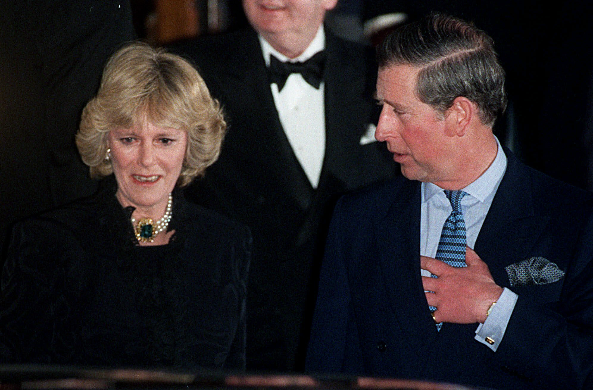 FILE - In this Thursday, Jan. 28, 1999 file photo, Britain's Prince Charles and his companion Camilla Parker Bowles leave the Ritz Hotel in London, the first time that the couple, who have been friends for more than 25 years, have appeared together in public. Prince Charles has been preparing for the crown his entire life. Now, that moment has finally arrived. Charles, the oldest person to ever assume the British throne, became king on Thursday Sept. 8, 2022, following the death of his mother, Queen Elizabeth II. (AP Photo/Alastair Grant, File)