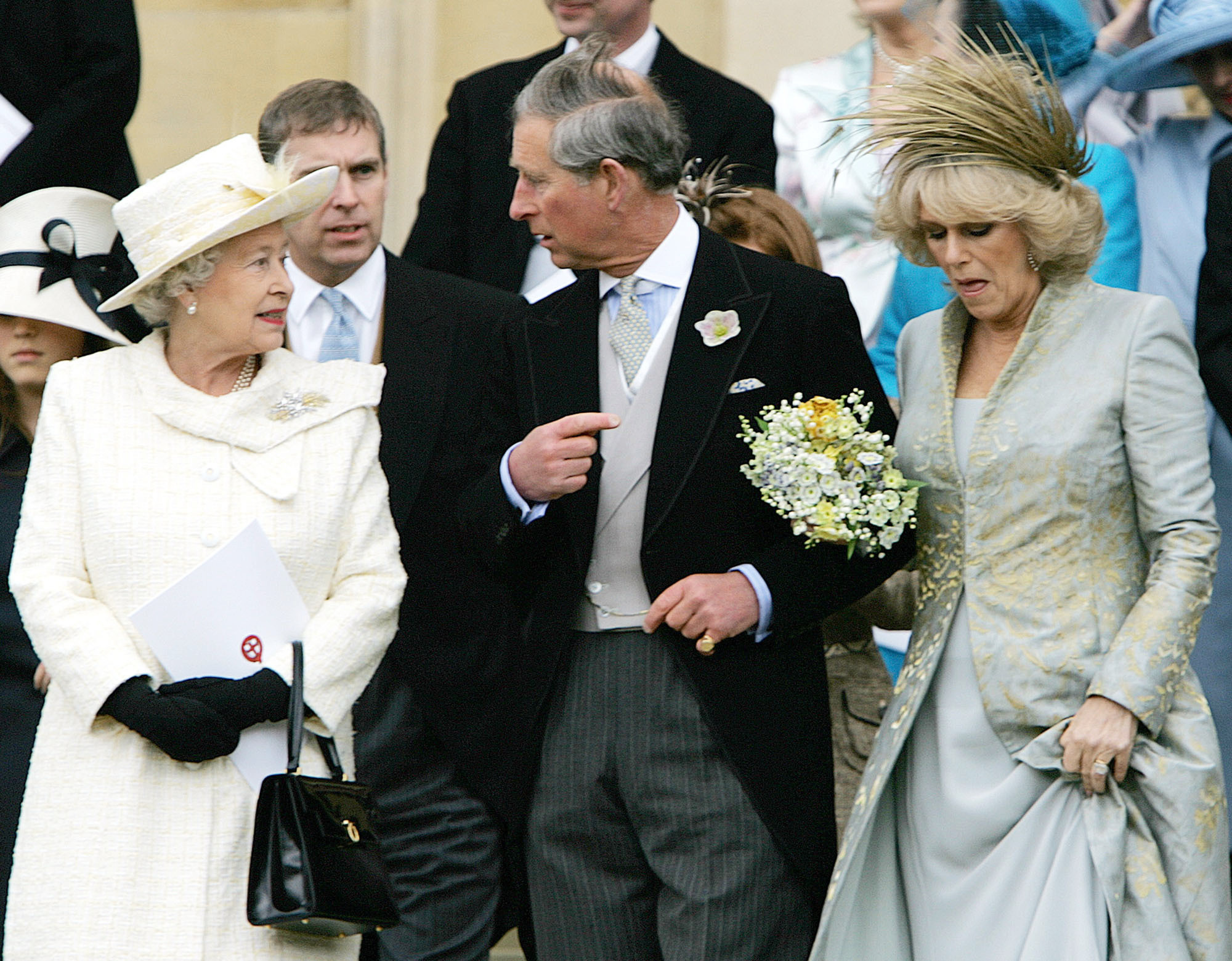 FILE - In this Saturday, April 9, 2005 file photo, Britain's Queen Elizabeth II speaks to Prince Charles, with his bride Camilla Duchess of Cornwall, right, as they leave St George's Chapel in Windsor, England following the church blessing of their civil wedding ceremony. Prince Charles has been preparing for the crown his entire life. Now, that moment has finally arrived. Charles, the oldest person to ever assume the British throne, became king on Thursday Sept. 8, 2022, following the death of his mother, Queen Elizabeth II. (AP Photo/ Alastair Grant, Pool, File)