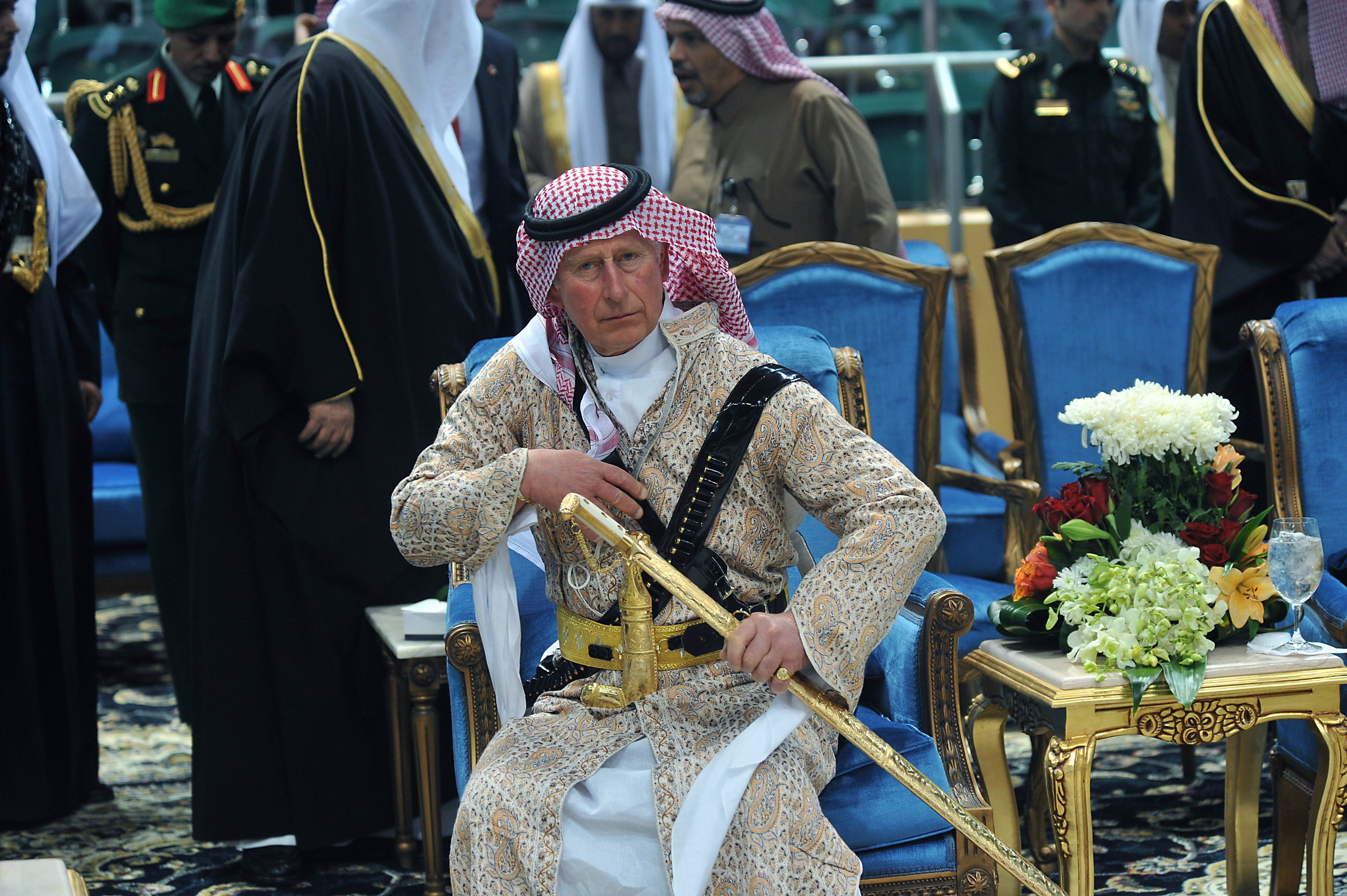 FILE - In this Feb. 18, 2014 file photo, Britain's Prince Charles wears a traditional Saudi uniform as he attends the traditional Saudi dancing best known as 