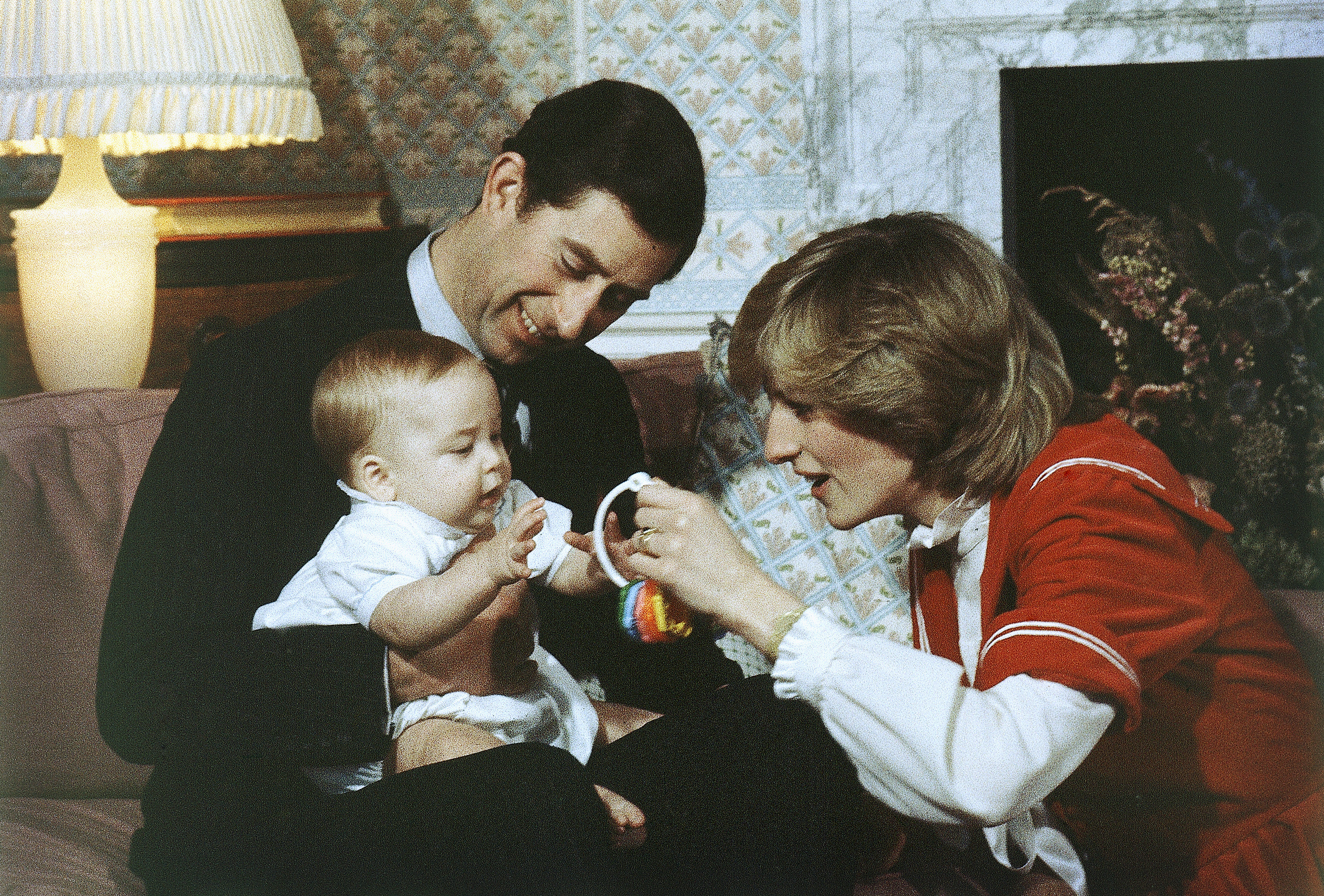 FILE - In this Dec. 22, 1982 file photo, Britain's Prince William, the 6-month old son of British Prince Charles and Princess Diana, the Prince and Princess of Wales interacts with his parents during a special photo call at Kensington Palace in London. Prince Charles has been preparing for the crown his entire life. Now, that moment has finally arrived. Charles, the oldest person to ever assume the British throne, became king on Thursday Sept. 8, 2022, following the death of his mother, Queen Elizabeth II. (AP Photo/David Caulkin, File)