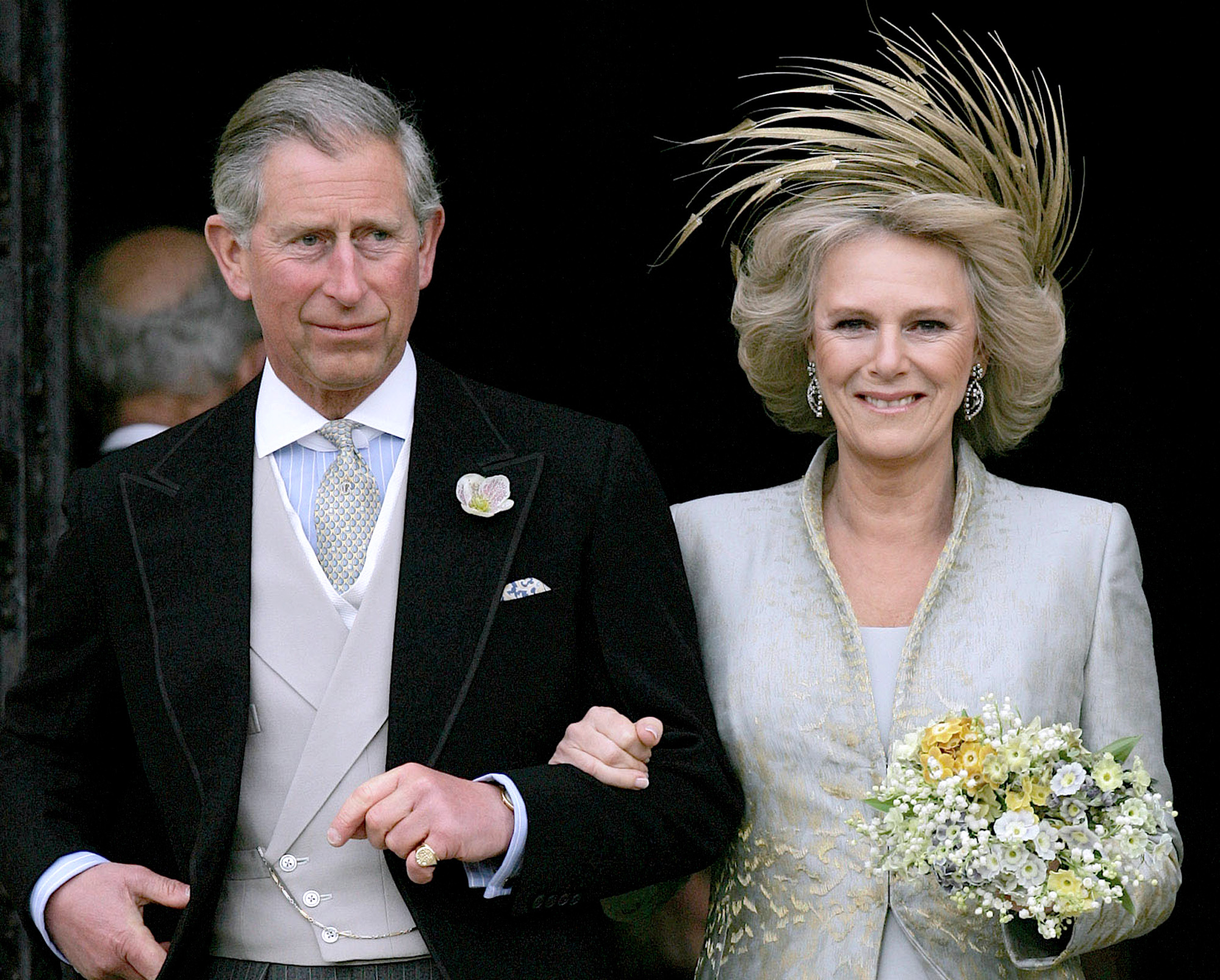 FILE - In this Saturday, April 9, 2005 file photo, Britain's Prince Charles and his bride Camilla Duchess of Cornwall leave St George's Chapel in Windsor, England following the church blessing of their civil wedding ceremony.  Prince Charles has been preparing for the crown his entire life. Now, that moment has finally arrived. Charles, the oldest person to ever assume the British throne, became king on Thursday Sept. 8, 2022, following the death of his mother, Queen Elizabeth II. (AP Photo/ Alastair Grant, Pool, File)