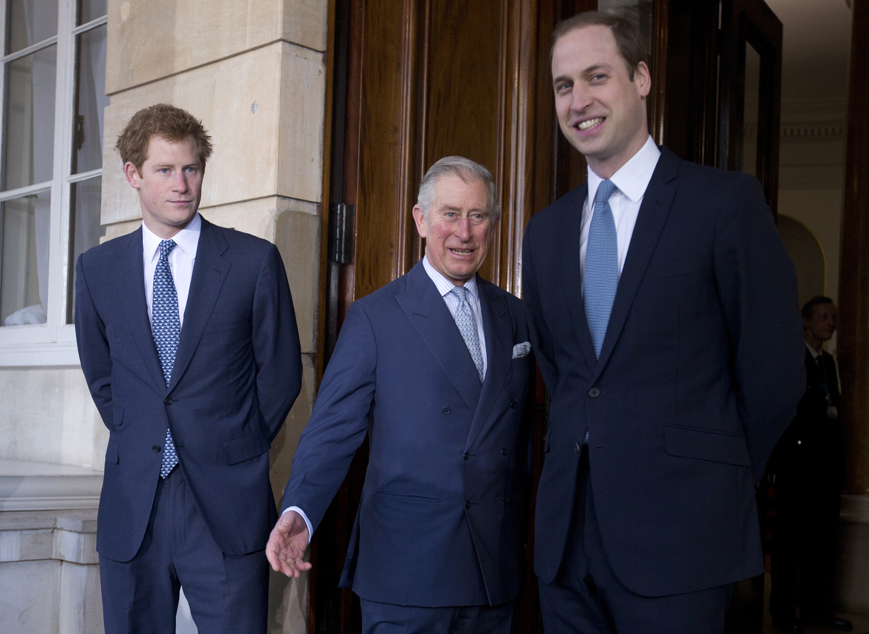 FILE - In this Feb. 13, 2014 file photo, Britain's Prince Charles, center, with his sons Prince William, right, and Prince Harry stops for the media outside Lancaster House as they arrive to attend the Illegal Wildlife Trade Conference in London. Prince Charles has been preparing for the crown his entire life. Now, that moment has finally arrived. Charles, the oldest person to ever assume the British throne, became king on Thursday Sept. 8, 2022, following the death of his mother, Queen Elizabeth II. (AP Photo/Alastair Grant, Pool, File)