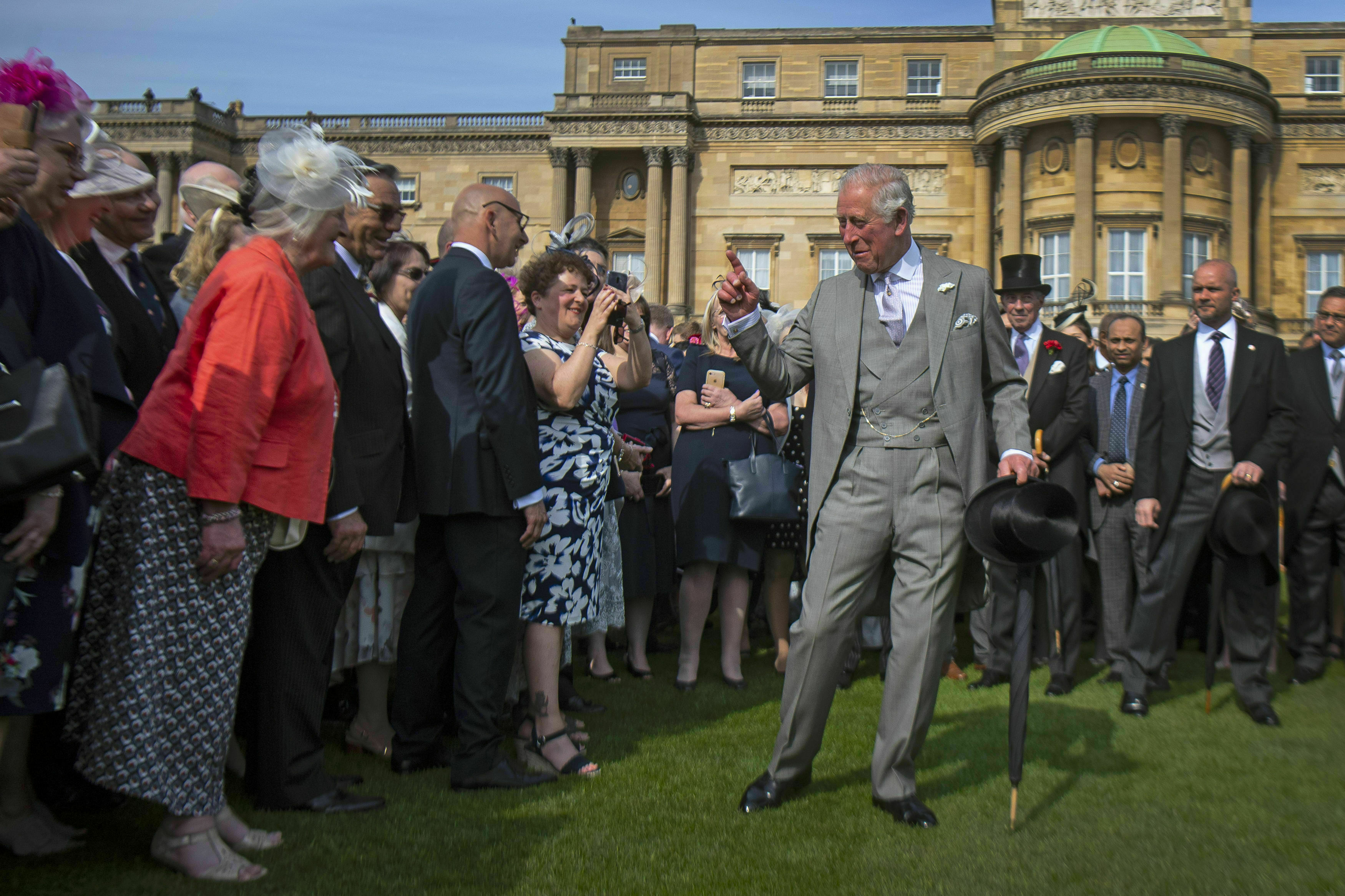 FILE - In this May 15, 2019 file photo, Britain's Prince Charles greets guests during a garden party at Buckingham Palace in London. Prince Charles has been preparing for the crown his entire life. Now, that moment has finally arrived. Charles, the oldest person to ever assume the British throne, became king on Thursday Sept. 8, 2022, following the death of his mother, Queen Elizabeth II. (Victoria Jones/Pool Photo via AP, File)
