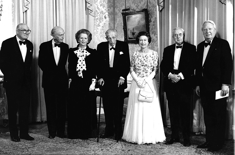 FILE - Britain's Queen Elizabeth II, centre right and Prime Minister Margaret Thatcher, centre left pose with former British premiers at a dinner at London's 10 Downing Street, Dec. 4, 1985, to celebrate the 250th anniversary of the British prime minister's London residence. From left,  James Callaghan, Alec Douglas-Home,   Harold Macmillan, Harold Wilson and Edward Heath. In seven decades on the throne, Queen Elizabeth II saw 15 British prime ministers come and go, from Winston Churchill to Margaret Thatcher to Boris Johnson to Liz Truss.  (Pool Photo via AP, File)