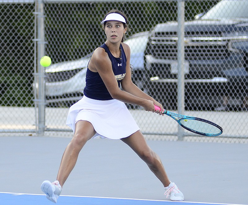 Lily Delk of Helias eyes a ball during her singles match in Thursday afternoon's dual against Capital City at the Crusader Athletic Complex. (Eileen Wisniowicz/News Tribune)