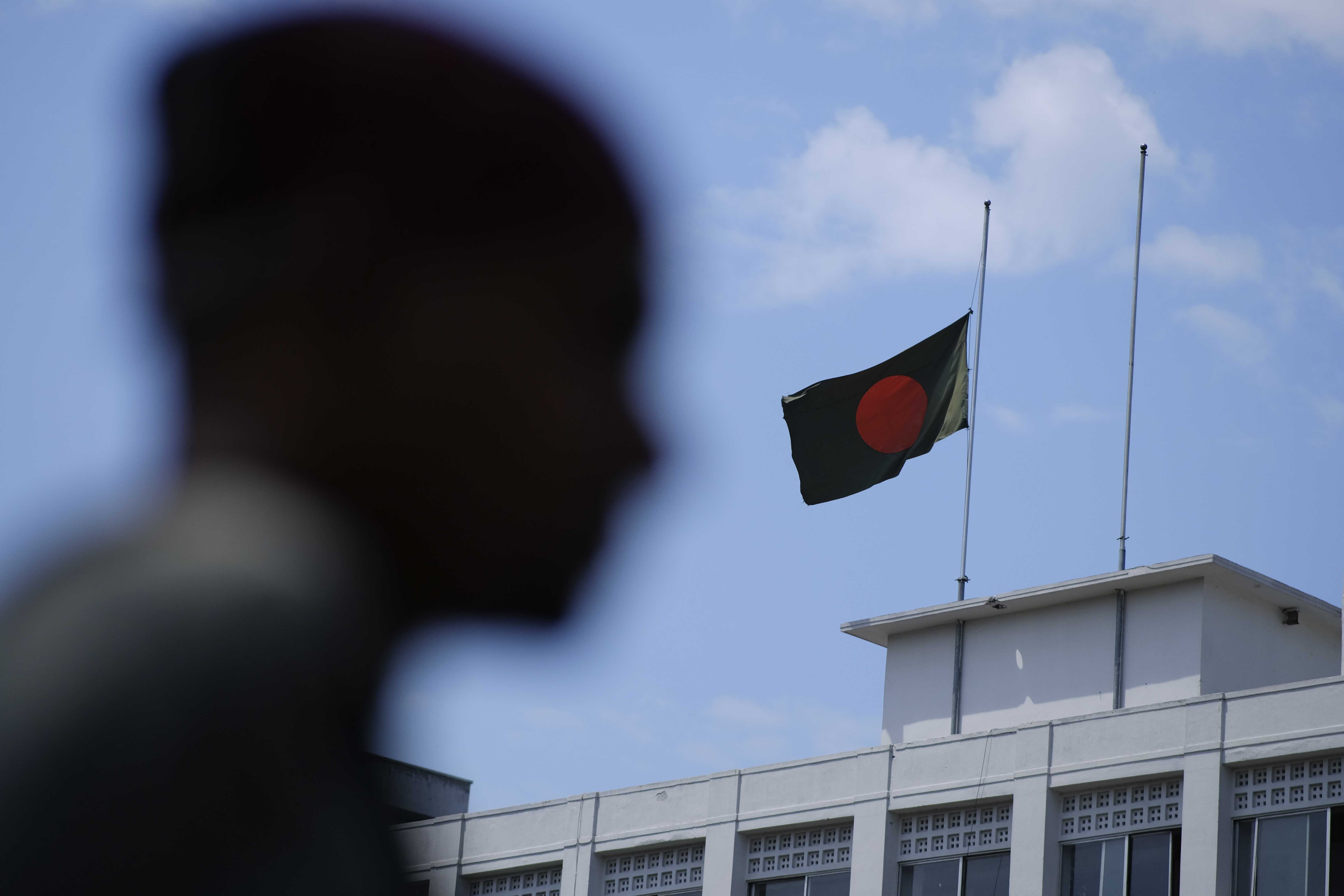 Bangladesh's national flag flies at half-mast following the demise of Britain's Queen Elizabeth II in Dhaka, Bangladesh, Friday, Sept. 9, 2022. Britain's longest-reigning monarch and a rock of stability across much of a turbulent century, died Thursday Sept. 8, 2022, after 70 years on the throne. She was 96. (AP Photo/Mahmud Hossain Opu)