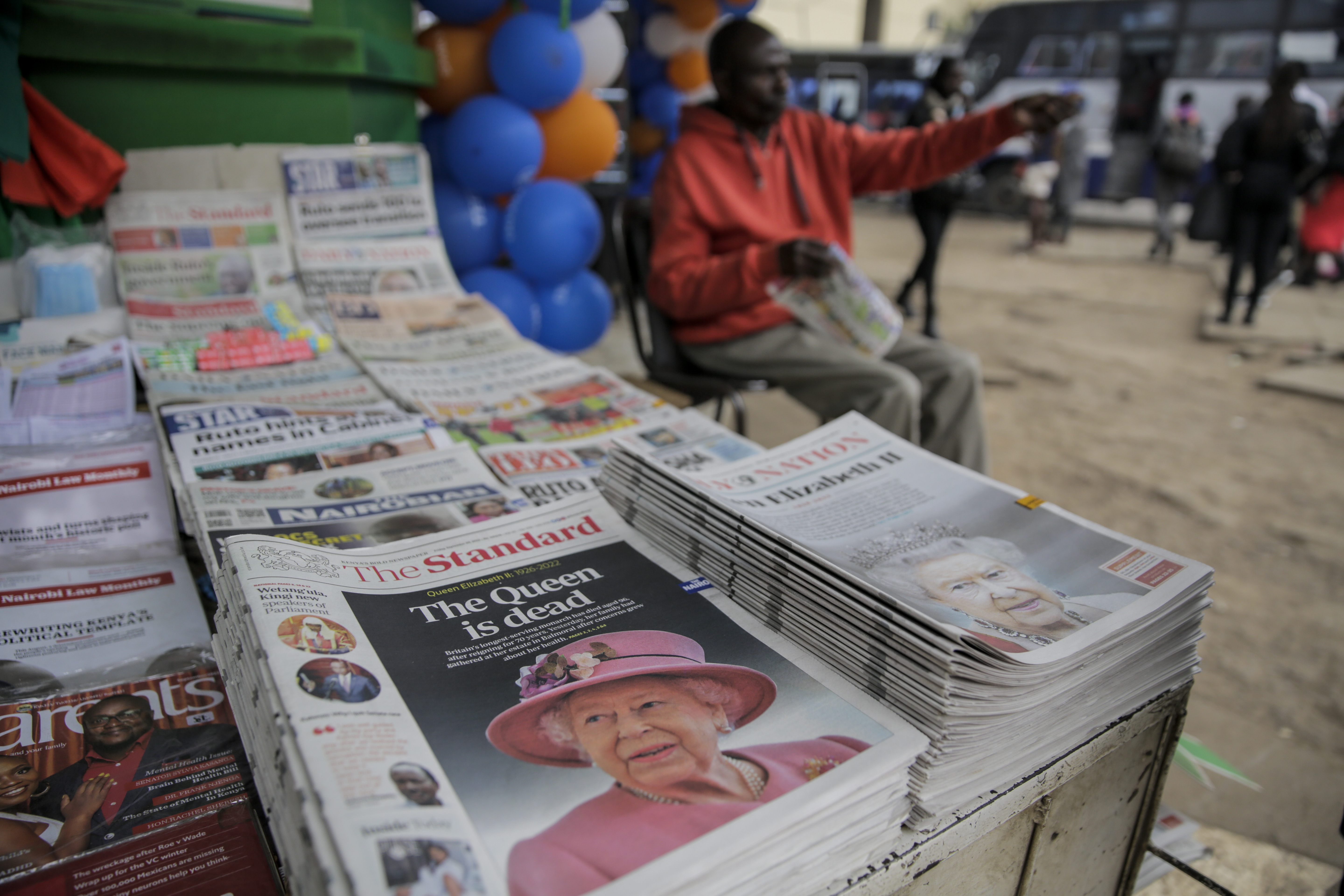 Kenyan newspapers show coverage of the death of Queen Elizabeth II, at a stand in downtown Nairobi, Kenya Friday, Sept. 9, 2022. Queen Elizabeth II, Britain's longest-reigning monarch and a rock of stability across much of a turbulent century, died Thursday after 70 years on the throne. She was 96. (AP Photo/Brian Inganga)