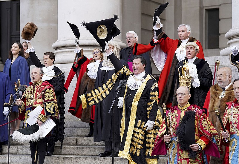 Officials and elected members of the city of London doff their hats and cheer Saturday outside the Royal Exchange before the reading of the Proclamation of Accession of King Charles III. More photos at arkansasonline.com/911charlesiii/.
(AP/PA/James Manning)