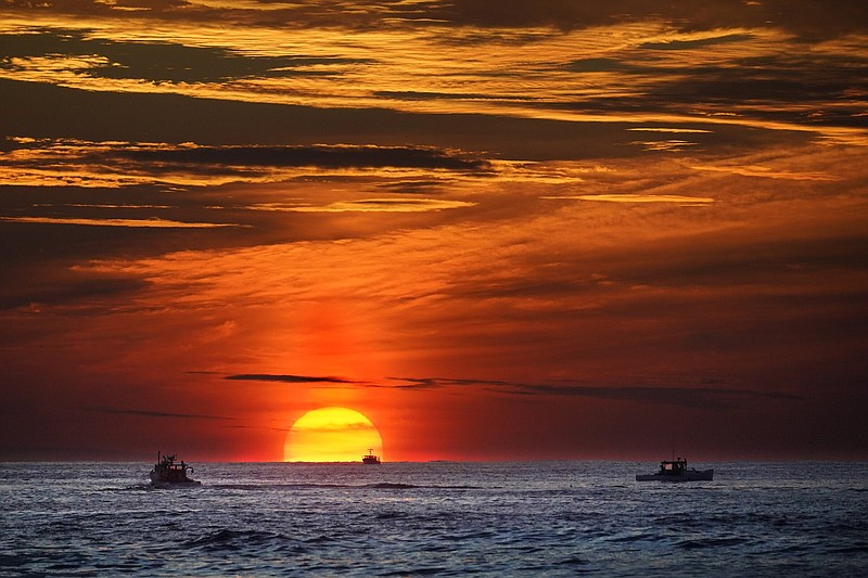 Lobster fishermen are already at work as the sun rises over the Atlantic Ocean, earlier this month, off of Kennebunkport, Maine.
(AP/Robert F. Bukaty)