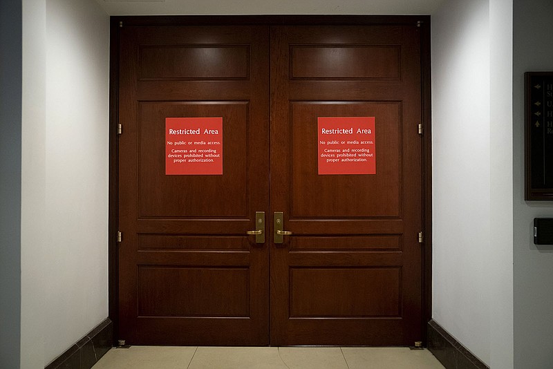 Signs alert non-authorized personnel at the entrance to the House Sensitive Compartmented Information Facility, located three levels beneath the Capitol. Congress keeps classified documents secured in an elaborate system of government protocols and high-level security clearances, a stark contrast to the stash of secrets at Mar-a-Lago.
(AP/J. Scott Applewhite)