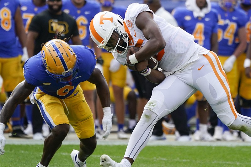 Pittsburgh defensive back Brandon Hill (9) chases Tennessee quarterback Hendon Hooker (5) as he scrambles during the first half of an NCAA college football game, Saturday, Sept. 10, 2022, in Pittsburgh. (AP Photo/Keith Srakocic)