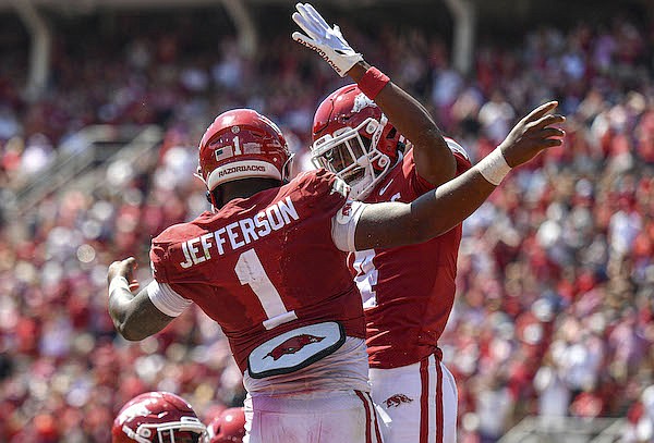 Arkansas quarterback KJ Jefferson (1) and receiver Malik Hornsby (4) celebrate during a game against South Carolina on Saturday, Sept. 10, 2022, in Fayetteville.