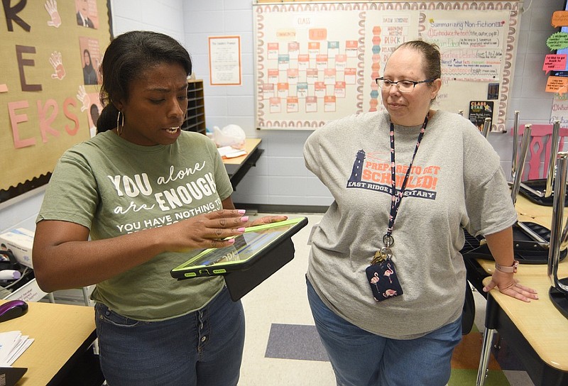 Staff photo by Matt Hamilton / Fourth grade reading teacher Tamela Cooley, left, talks about a tablet that can mirror and enlarge the class projector screen as special education teacher Heather Modrow looks on at East Ridge Elementary School on Friday, September 9, 2022.