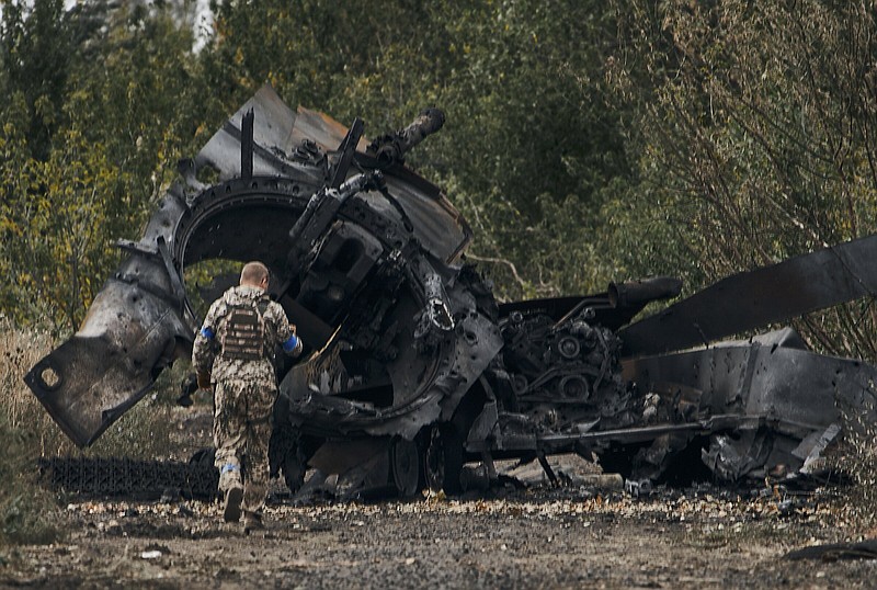 A Ukrainian soldier passes by a Russian tank Sunday which was damaged in a battle in a just-freed territory on the road to Balakleya in the Kharkiv region of Ukraine.
(AP)