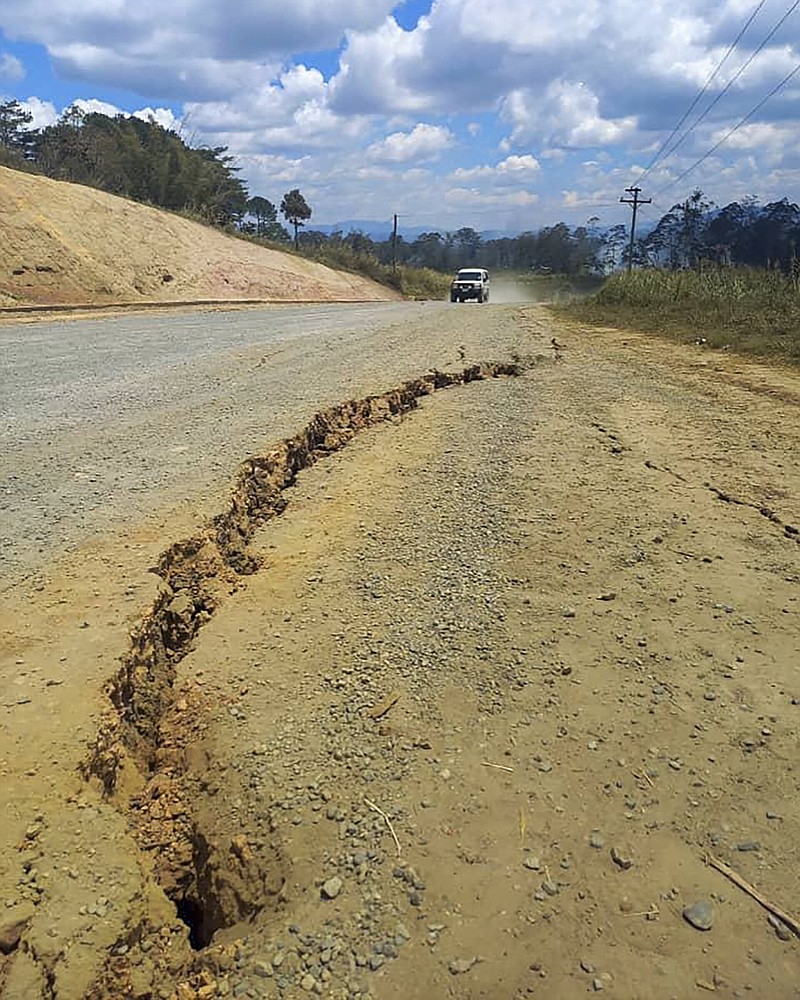 A large crack is seen in a highway on Sunday near the town of Kainantu, following a 7.6-magnitude earthquake in northeastern Papua New Guinea.
(AP/Renagi Ravu)