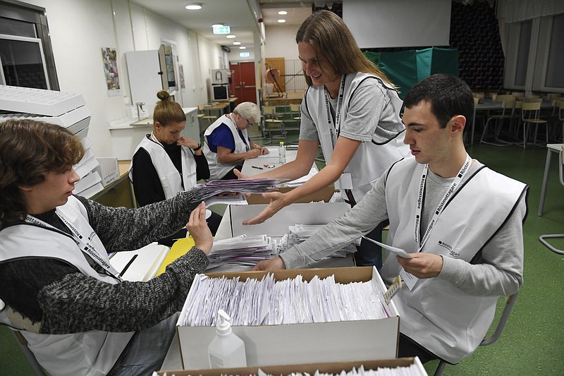 Poll workers count votes at a polling station on Sunday at Vilans school in Nacka near Stockholm, Sweden. More photos at arkansasonline.com/912sweden/.
(AP/TT News Agency/Maja Suslin)