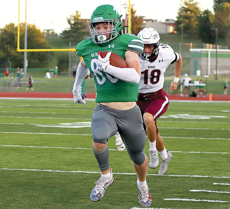 Blair Oaks wide receiver Nick Closser runs with the ball down the field for a touchdown past School of the Osage defensive back Max Cook during Friday night’s game at the Falcon Athletic Complex in Wardsville. (Kate Cassady/News Tribune)