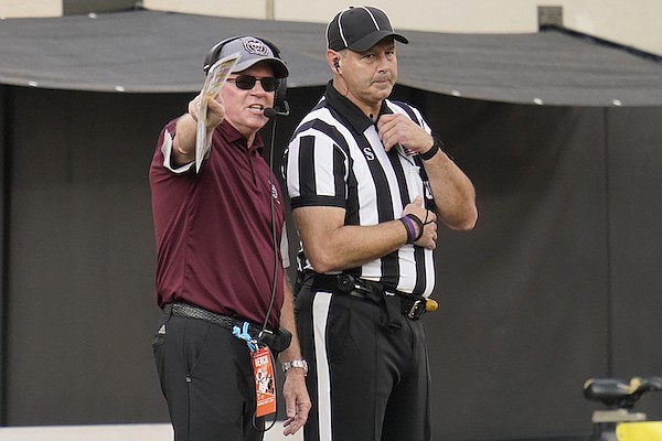 Missouri State head coach Bobby Petrino talks with an official in the first half of an NCAA college football game against Oklahoma State, Saturday, Sept. 4, 2021, in Stillwater, Okla. (AP Photo/Sue Ogrocki)