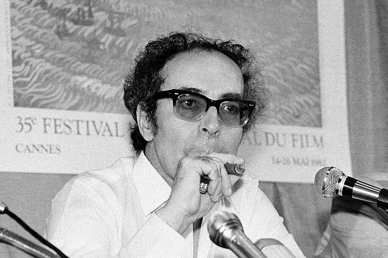 FILE - Film director Jean-Luc Godard smokes at Cannes festival, France on May 25, 1982. (AP/Jean-Jacques Levy, File)