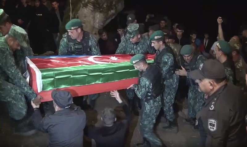 Servicemen carry a coffin of Azeri serviceman Shamistan Sadykhov killed at the Azerbaijani-Armenian border, during his funeral Tuesday in Lerik, Azerbaijan.
(AP)