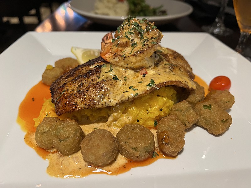 Allsopp & Chapple's Blackened Redfish, a "house signature item," features a redfish filet, topped by Pontchartrain sauce and a single "colossal" shrimp, surrounded by bits of fried okra, on a bed of basmati rice. (Arkansas Democrat-Gazette/Eric E. Harrison)