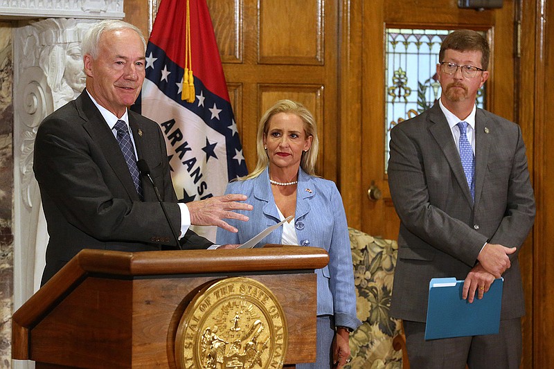 At a news conference Thursday at the state Capitol with Attorney General Leslie Rutledge and Education Secretary Johnny Key, Gov. Asa Hutchinson announces his opposition to proposed amendments to the regulations on implementing Title IX. “This would interfere with Arkansas law, it would interfere with common sense, and it would interfere with local control,” he said in a statement.
(Arkansas Democrat-Gazette/Thomas Metthe)